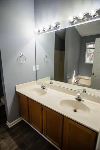 a bathroom with a double vanity sink and mirror