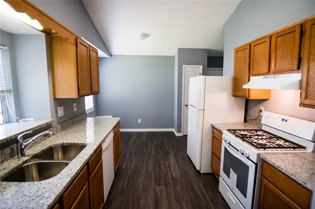 a kitchen with a sink stove and refrigerator