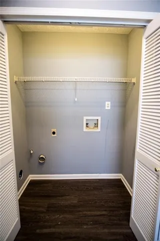 a view of water heater room with wooden floor