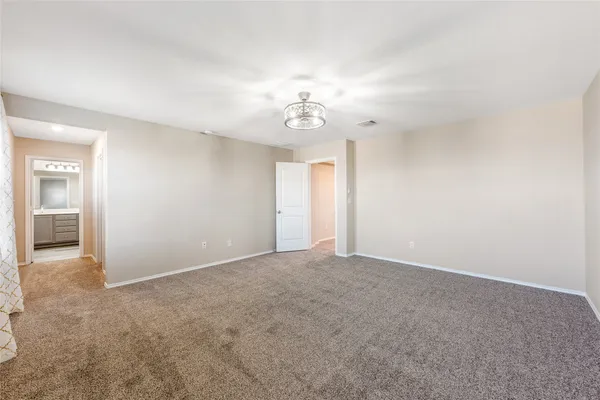 an empty room with windows and cabinet