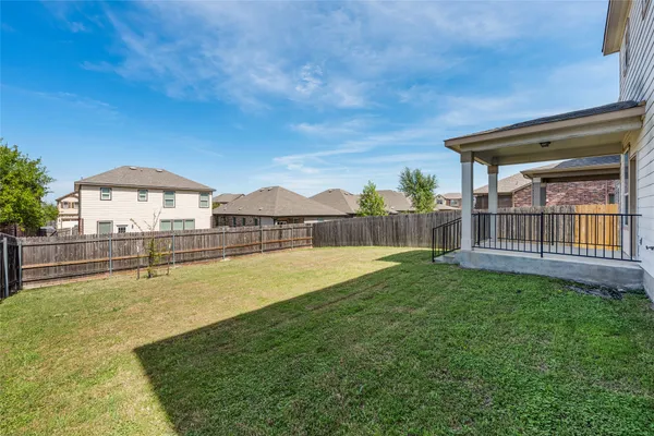 a view of a house with pool and a yard