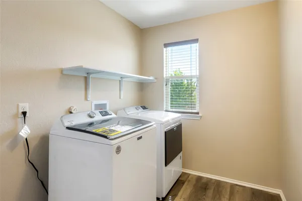 a utility room with a sink dryer and washer