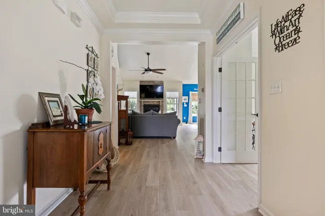 a view of a kitchen with fridge and wooden floor