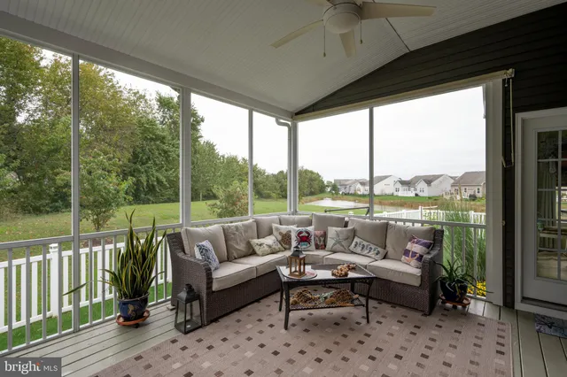 a front view of house with garden and trees
