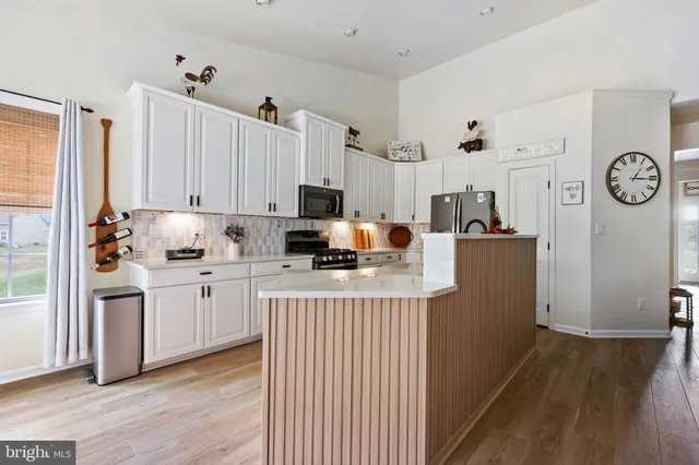 a kitchen with refrigerator and cabinets