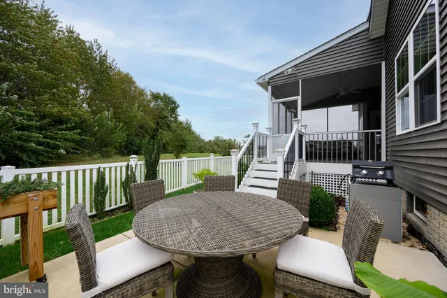 a living room with lots of furniture and a floor to ceiling window