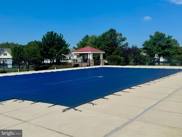 a view of swimming pool outdoor seating and green space
