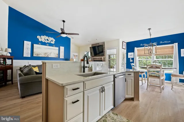 a kitchen with stainless steel appliances a refrigerator sink and cabinets