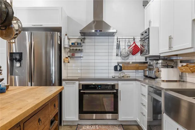 a kitchen with cabinets and stainless steel appliances
