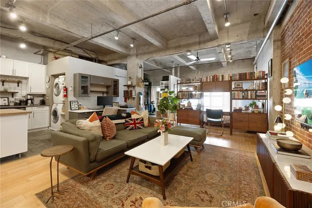 a living room with furniture and a kitchen view