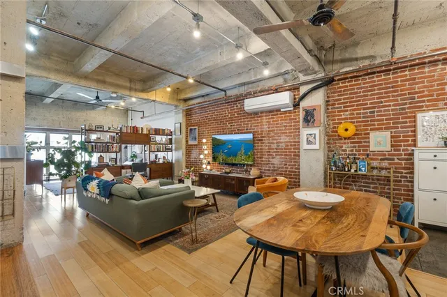 a living room with patio furniture and a flat screen tv