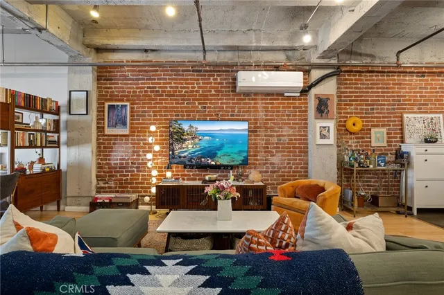 a living room with lots of furniture and kitchen view