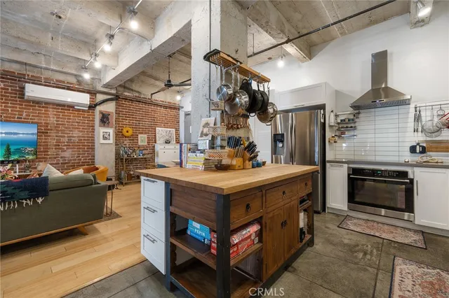 a kitchen with stainless steel appliances granite countertop a stove sink and cabinets
