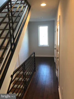a view of an entryway with wooden floor