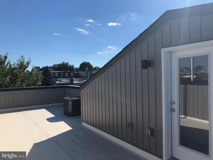 a balcony with table and chairs