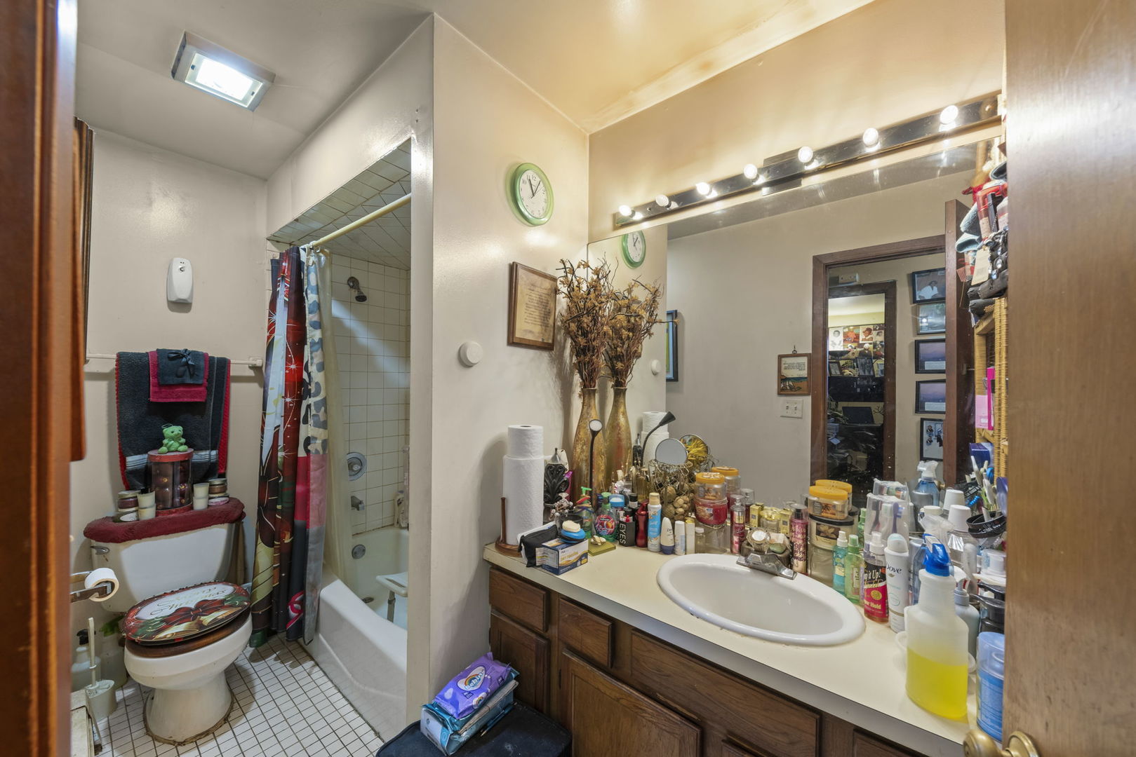 5700 St Charles Road Berkeley, IL 60163 - Photo 14 of 17 a bathroom with a sink vanity mirror and toilet
