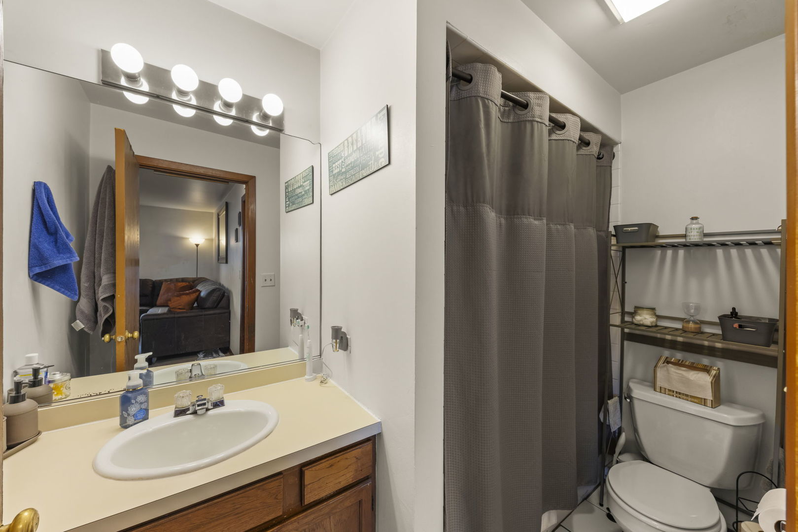 5700 St Charles Road Berkeley, IL 60163 - Photo 5 of 17 a bathroom with a sink a toilet a mirror and shower
