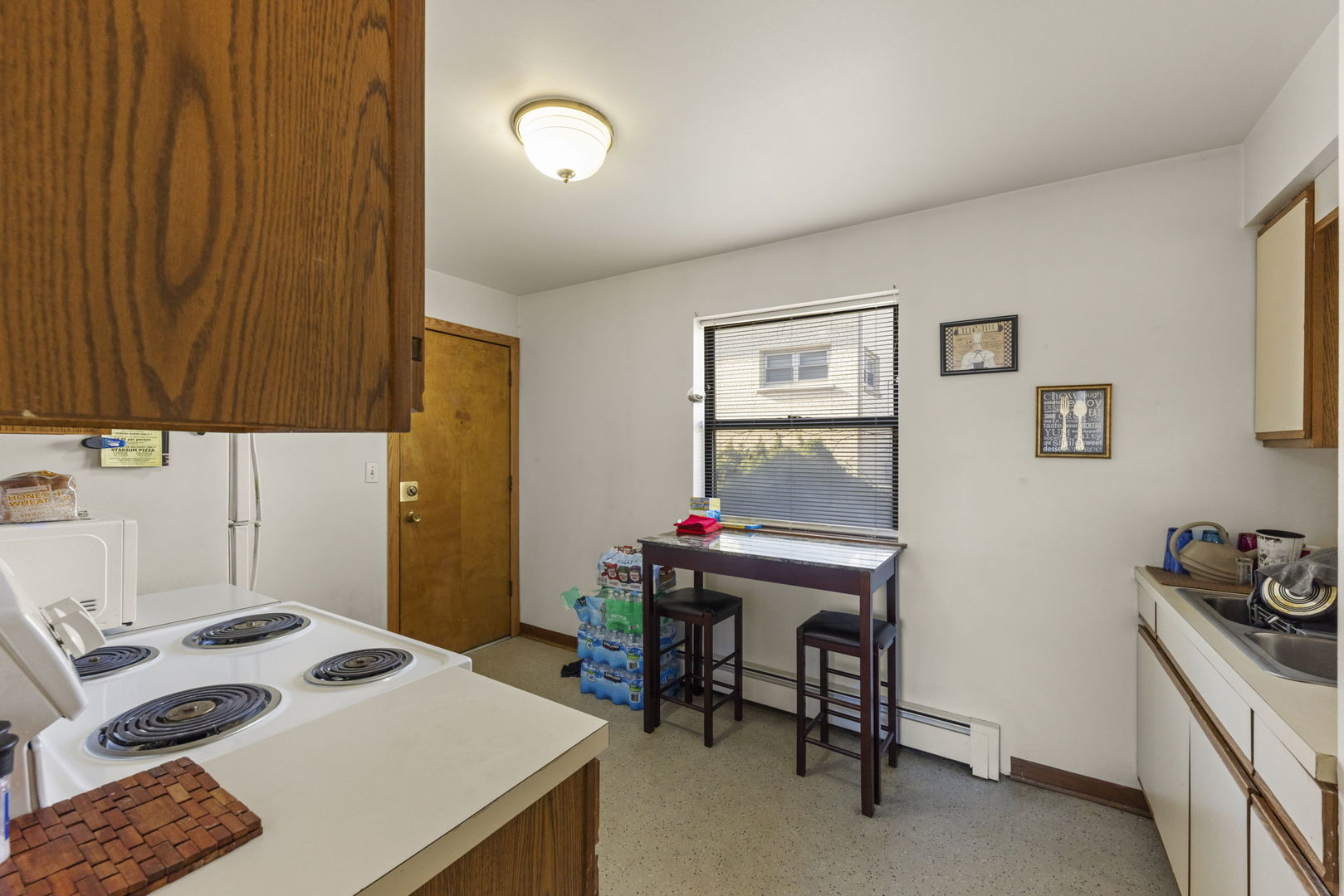 5700 St Charles Road Berkeley, IL 60163 - Photo 6 of 17 a bedroom with a bed and a table in it