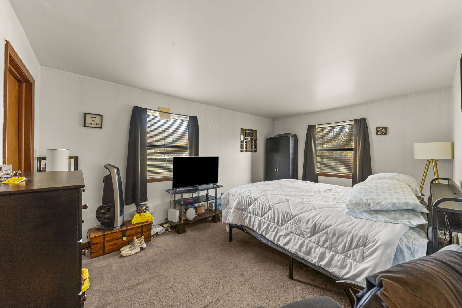 5700 St Charles Road Berkeley, IL 60163 - Photo 7 of 17 a bedroom with a bed and a flat screen tv