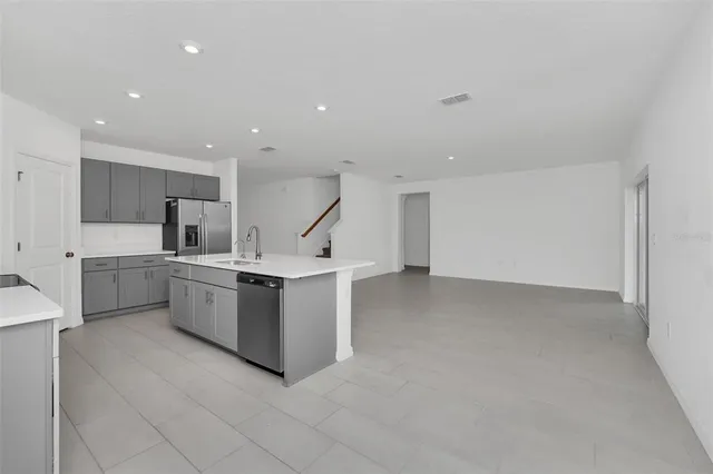 a kitchen with cabinets and white stainless steel appliances