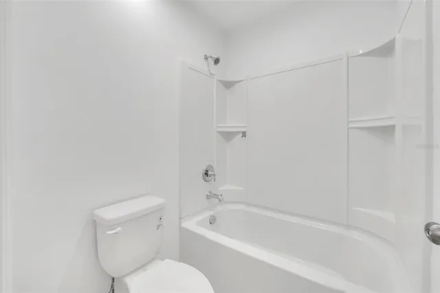 a bathroom with a toilet and bathtub