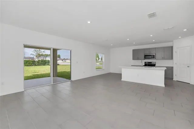 a view of a kitchen with a sink and a refrigerator