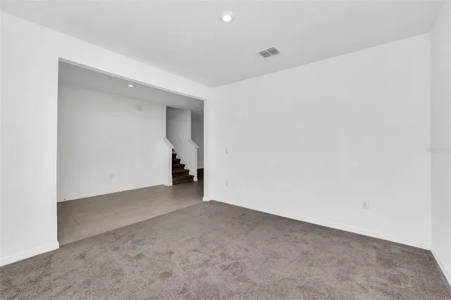 a view of kitchen with stainless steel appliances granite countertop a sink and a large window