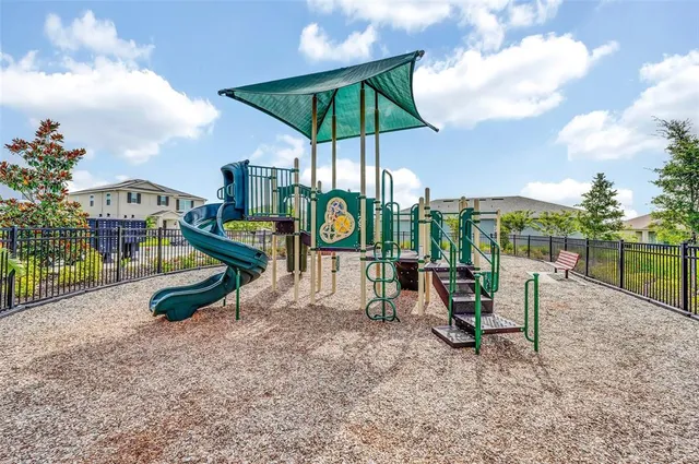 a view of a dining room with furniture a rug and wooden floor