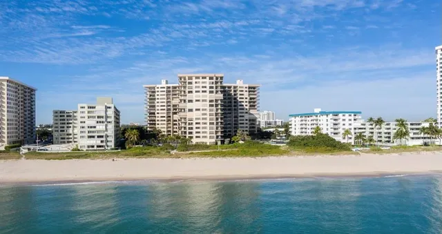 a view of swimming pool next to a building with lake view
