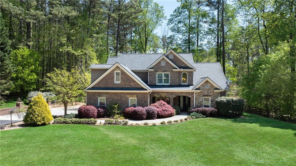 15725 Hopewell Road Milton, GA 30004 - Photo 1 of 1 a front view of a house with garden