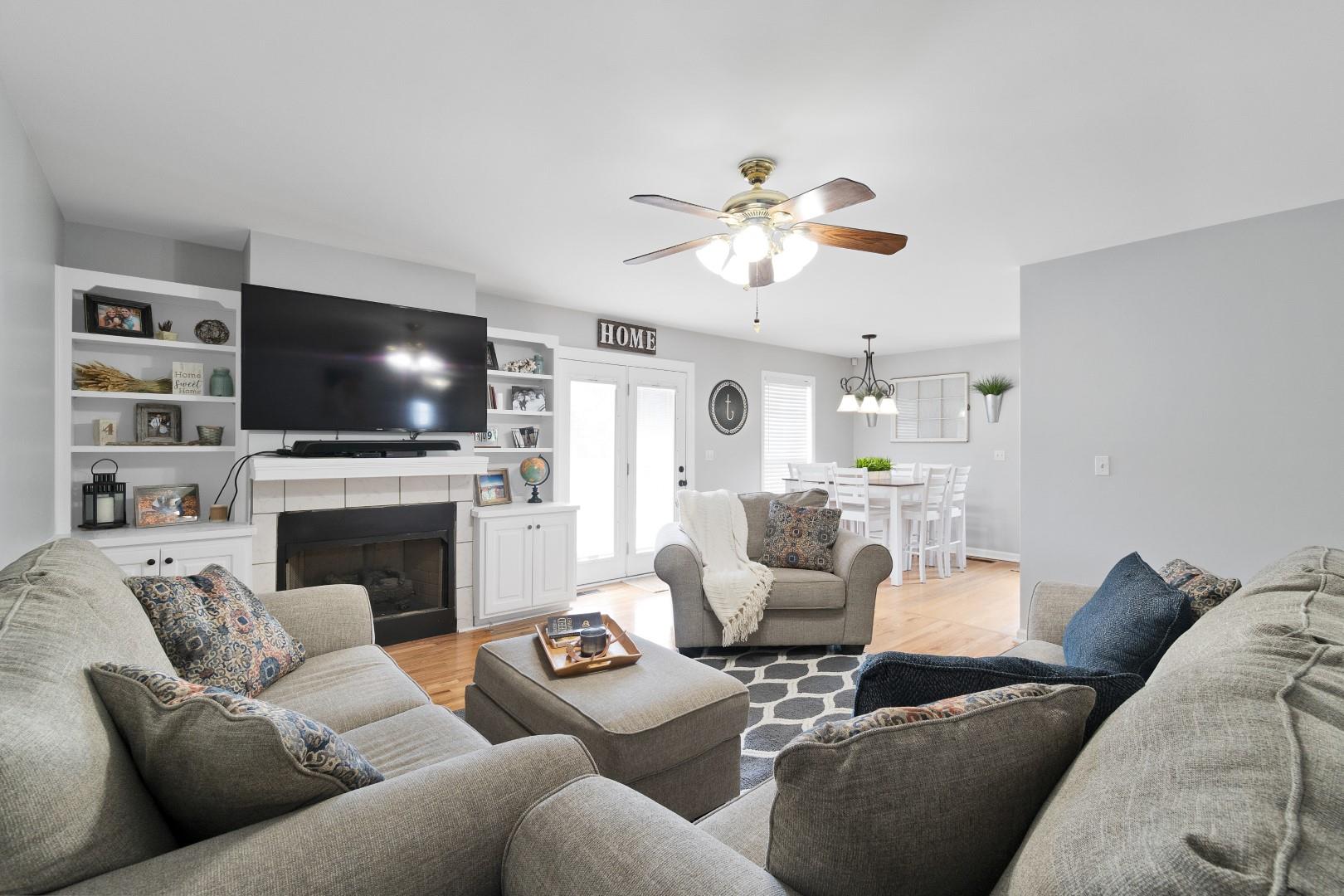 2225 Alvin Head Road Springfield, TN 37172 - Photo 9 of 24 a living room with furniture a fireplace and a flat screen tv