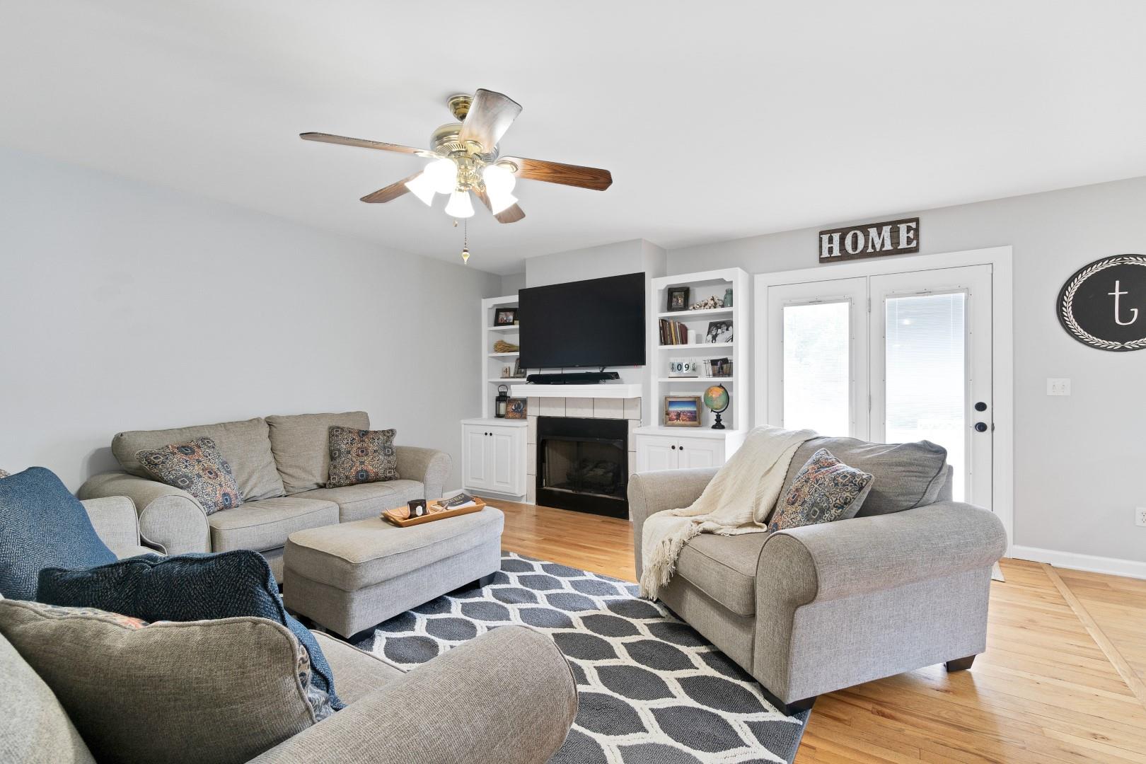 2225 Alvin Head Road Springfield, TN 37172 - Photo 10 of 24 a living room with furniture a flat screen tv and a fireplace