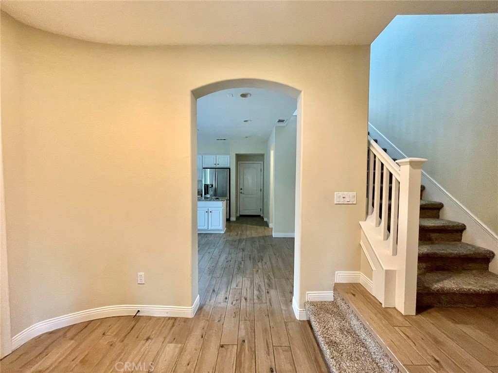 181 Rhapsody Irvine, CA 92620 - Photo 16 of 73 a view of a hallway view with wooden floor and staircase