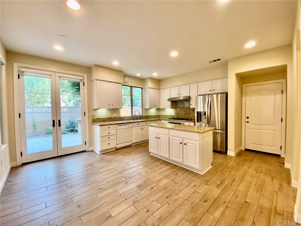 181 Rhapsody Irvine, CA 92620 - Photo 19 of 73 a large kitchen with stainless steel appliances granite countertop a stove a sink and a refrigerator