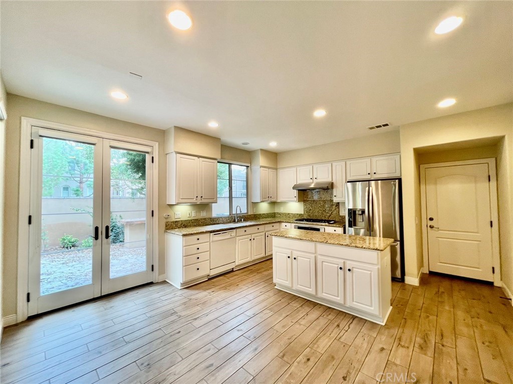181 Rhapsody Irvine, CA 92620 - Photo 22 of 73 a large kitchen with a large window a sink and stainless steel appliances
