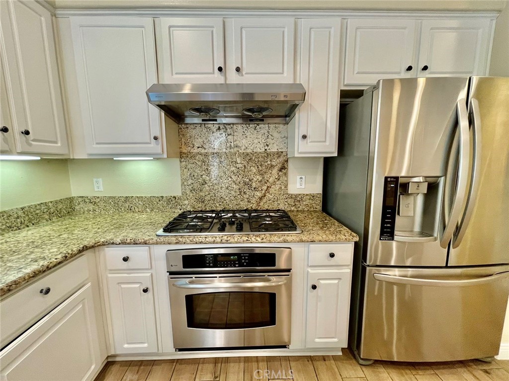 181 Rhapsody Irvine, CA 92620 - Photo 25 of 73 a kitchen with a stove and a refrigerator