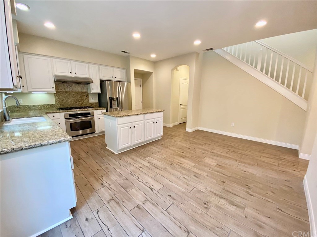 181 Rhapsody Irvine, CA 92620 - Photo 26 of 73 an open kitchen with kitchen island and stainless steel appliances