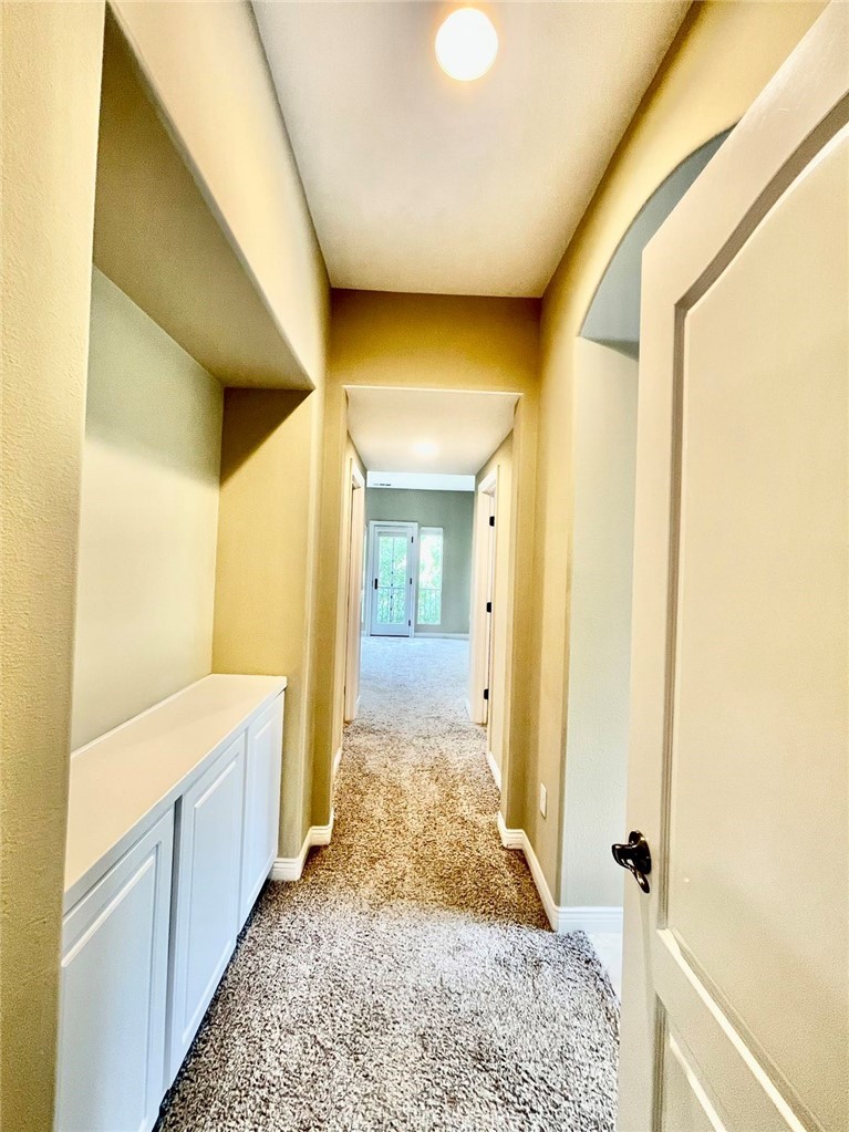 181 Rhapsody Irvine, CA 92620 - Photo 45 of 73 a view of a hallway with wooden floor and cabinet