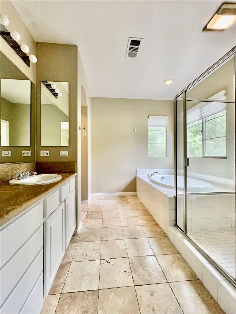 181 Rhapsody Irvine, CA 92620 - Photo 46 of 73 a bathroom with a sink a mirror and a bathtub