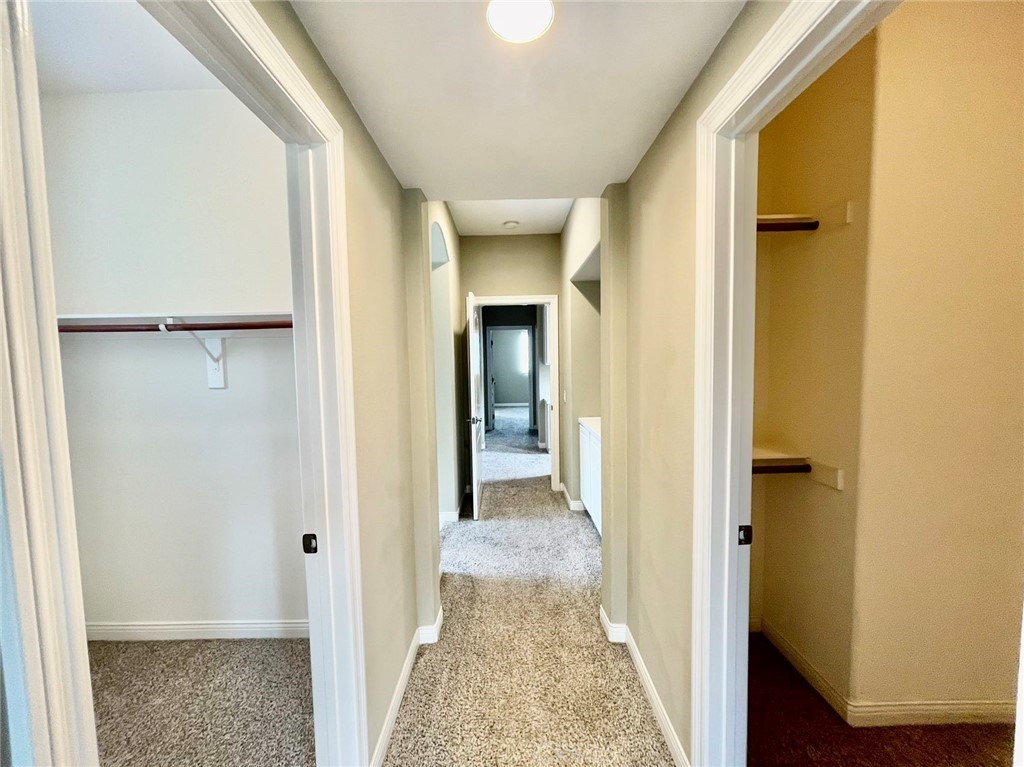 181 Rhapsody Irvine, CA 92620 - Photo 54 of 73 a view of a hallway with wooden floor and closet
