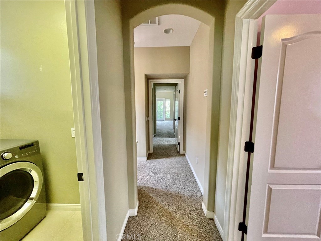 181 Rhapsody Irvine, CA 92620 - Photo 59 of 73 a view of a hallway with washer and dryer