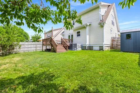 a view of a house with a backyard