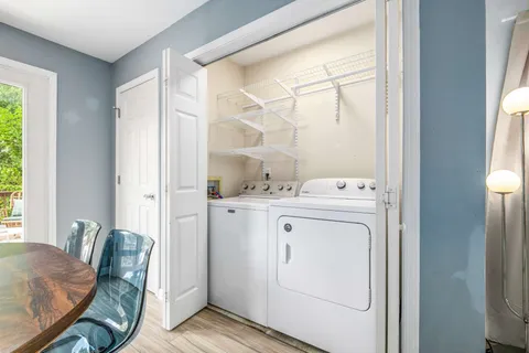 a kitchen with a table chairs refrigerator and a television