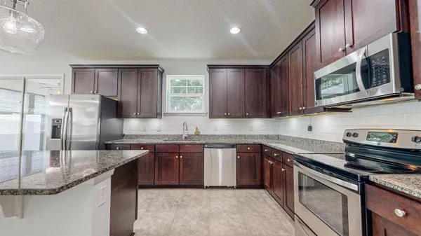 a kitchen with a stove top oven sink and cabinets