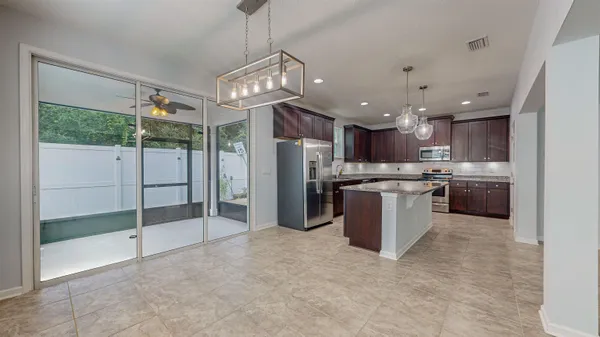 a view of large kitchen with a sink and a window