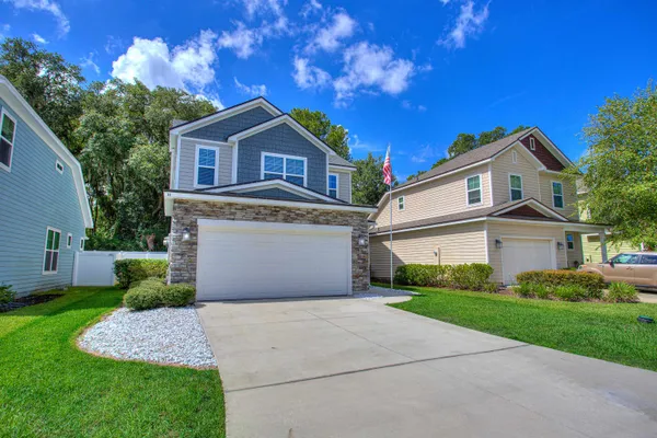 a front view of a house with a yard and garage