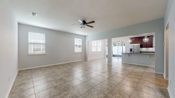 a view of an empty room with a kitchen