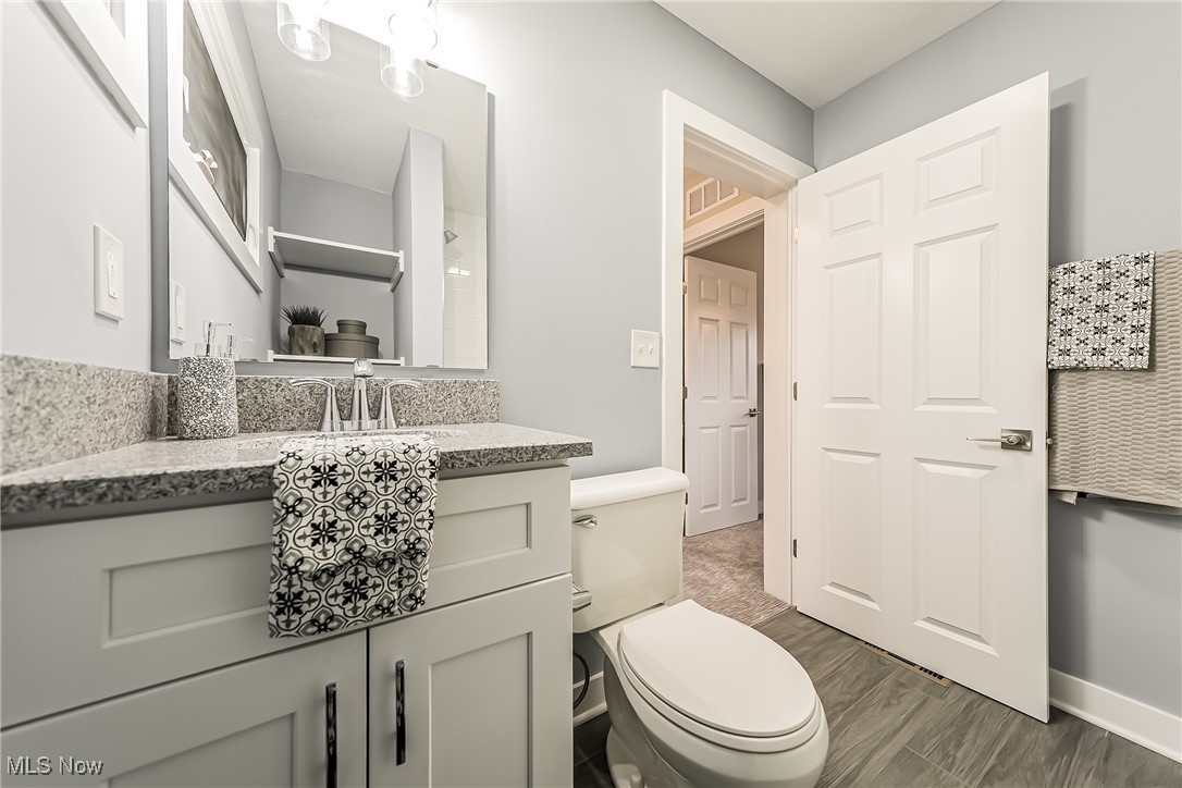 1240 Dorsh Road Cleveland, OH 44121 - Photo 20 of 36 Second floor bathroom with vanity, toilet, and ceramic tile floors