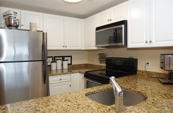 8 Museum Way, Unit 802 Cambridge, MA 02141 - Photo 8 of 13 a kitchen with stainless steel appliances granite countertop a refrigerator stove top oven and sink