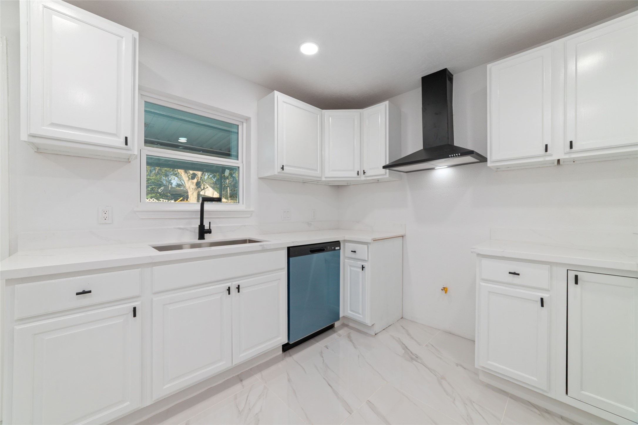 11434 Sharpview Drive Houston, TX 77072 - Photo 11 of 25 a kitchen with white cabinets and sink